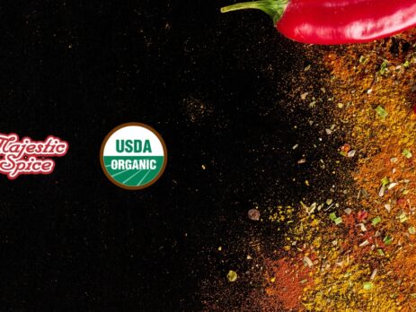 Majestic Spice Logo, the USDA organic logo, and in the right of the picture a chili in the corner and powdered spices like chili, curry, and others. Black background